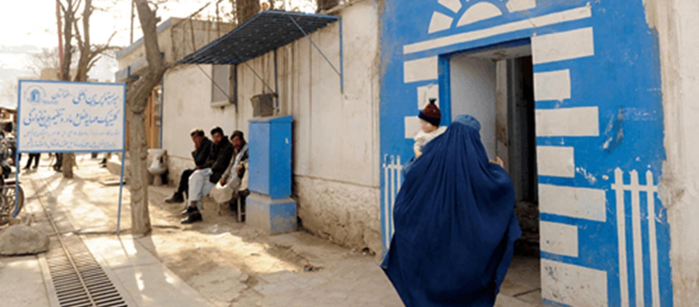 Woman enters through MSI's blue door in Afghanistan